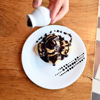 Side view of White Moon Botanica 7.75" Opal Glass Dessert Plate, Sfere (Set of 24)