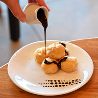 Side view of White Moon Botanica 7.75" Opal Glass Dessert Plate, Sfere (Set of 24)