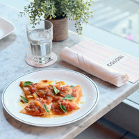 Side view of White Moon Chiaroscuro 10.75" Opal Glass Dinner Plate, Unico (Set of 24)