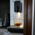 Espresso being dispensed into a glass from a coffee machine.