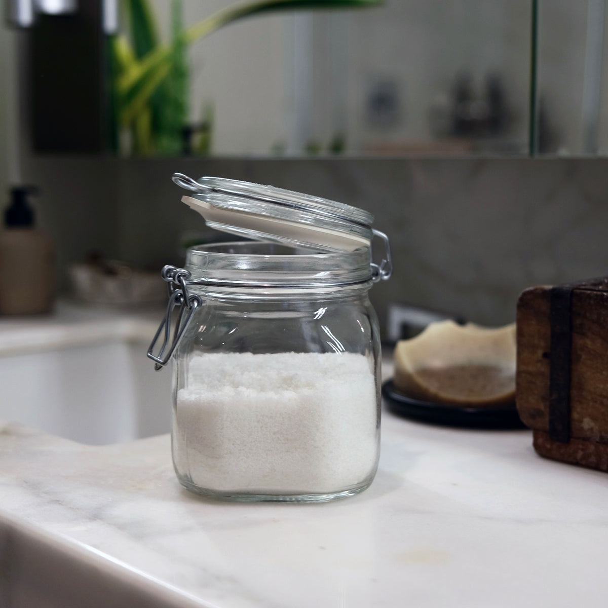 Clear glass jar with white contents on a kitchen counter